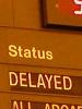 A departure board with DELAYED on it. How amusing.